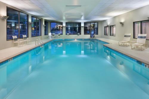 a swimming pool with blue water in a building at Radisson Hotel Nashville Airport in Nashville