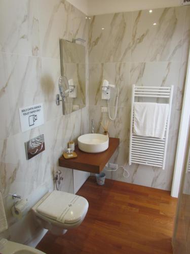 a bathroom with a sink and a toilet at Room 56 - Le Dimore in Bari