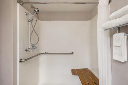 a shower in a bathroom with white towels at Country Inn & Suites by Radisson, Mt Pleasant-Racine West, WI in Sturtevant