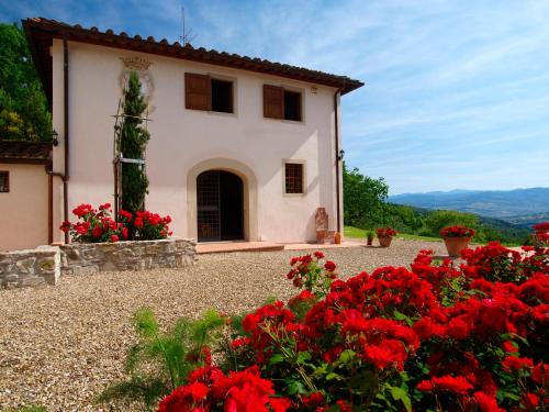 a house with red flowers in front of it at Casignano in Bagno a Ripoli