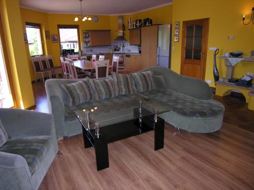 a living room with a couch and a table at Villa Holiday in Karlovy Vary
