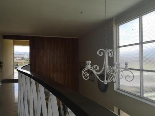 a staircase in a house with a chandelier at HOTEL TERRAZAS BOUTIQUE in Los Yoses