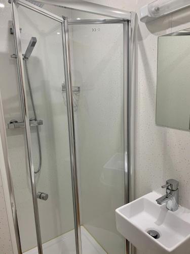 a bathroom with a shower and a sink at The Island & Fairfield in Douglas
