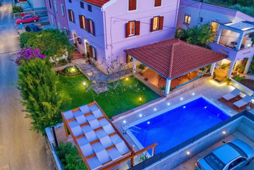 an overhead view of a house with a swimming pool at Apartments Guc in Preko