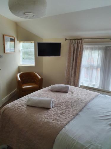 a bedroom with a bed with two towels on it at The Flowerpot in Derby