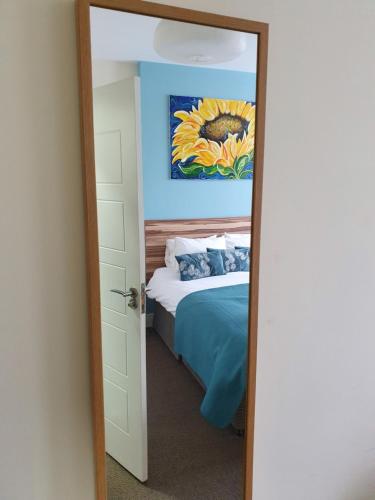 a bedroom with a bed and a mirror at The Flowerpot in Derby
