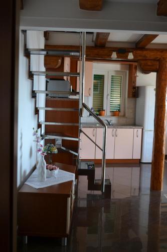 a kitchen with a staircase and a table in a room at Apartments Karlo in Omiš