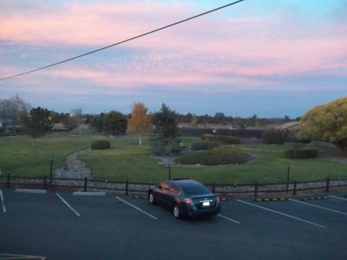 a black car parked in a parking lot at Grand Canyon Inn and Motel - South Rim Entrance in Valle