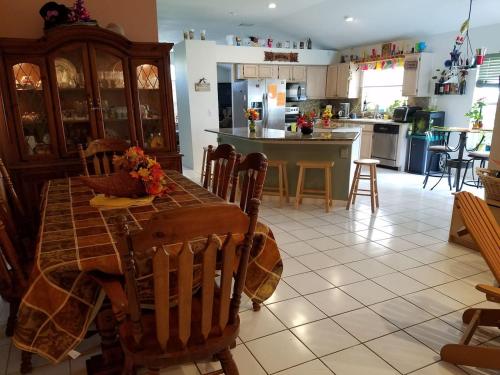 a kitchen with a table and chairs and a kitchen with a counter at Cozy and Conveniently located Pool Home with Free WiFi in Tampa