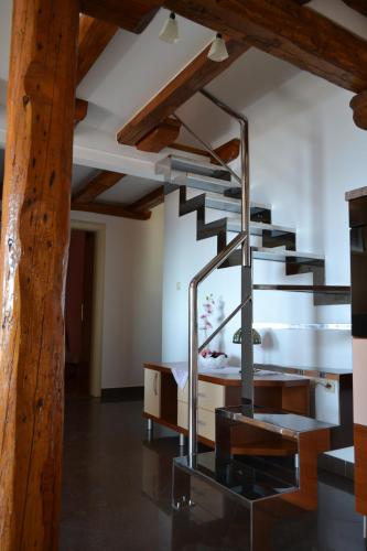 a spiral staircase in a room with wooden ceilings at Apartments Karlo in Omiš