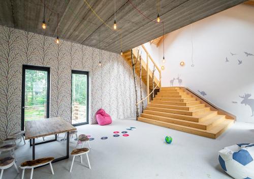 a room with stairs and a table and chairs at Samota Hojšín in Neustupov