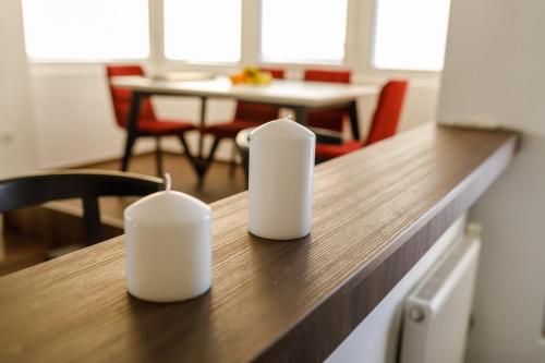 two white containers sitting on top of a kitchen counter at Kristall Apartments 2 Panorama in Šabac