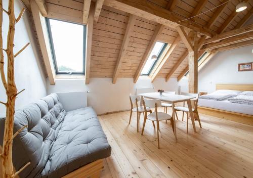 a living room with a couch and a table at Samota Hojšín in Neustupov