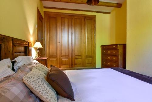 a bedroom with a bed with two pillows on it at Cal Gineró in Vall de Castellbò