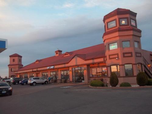a building with a clock tower in a parking lot at Grand Canyon Inn and Motel - South Rim Entrance in Valle