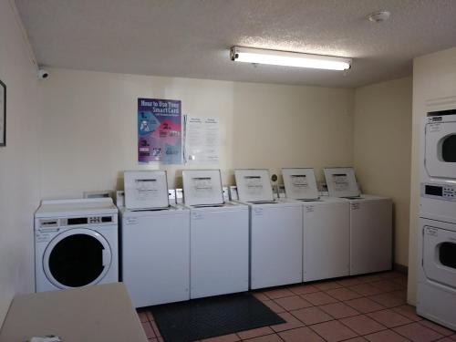 a laundry room with a row of washers and dryers at InTown Suites Extended Stay Albuquerque NM in Albuquerque