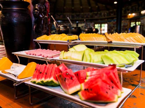 a bunch of different types of fruit on trays at aha Lesedi African Lodge & Cultural Village in Pelindaba