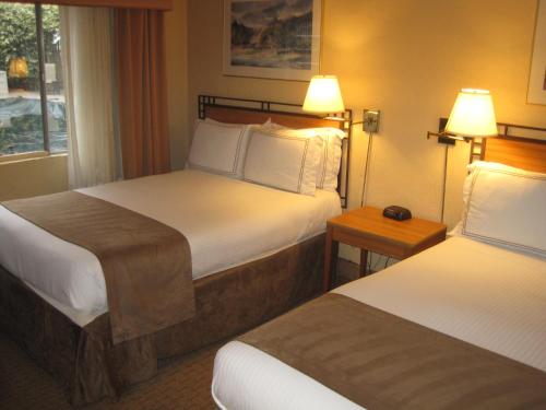 a hotel room with two beds and two lamps at Travelodge by Wyndham Seattle By The Space Needle in Seattle