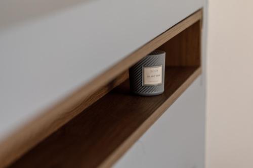 a candle on a shelf in a room at Kristall Apartments 2 Panorama in Šabac