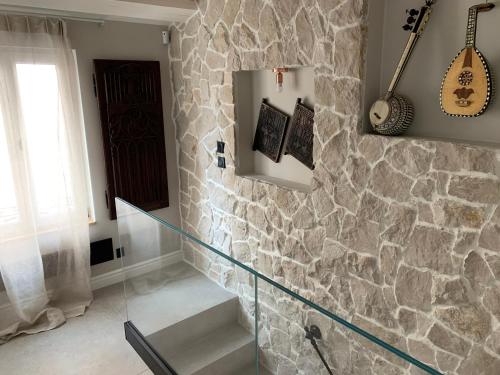 a glass staircase in a room with a stone wall at Cannes cote sud in Cannes
