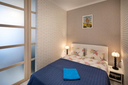 a bedroom with a bed with a blue pillow on it at Riga Centre Apartment in Riga