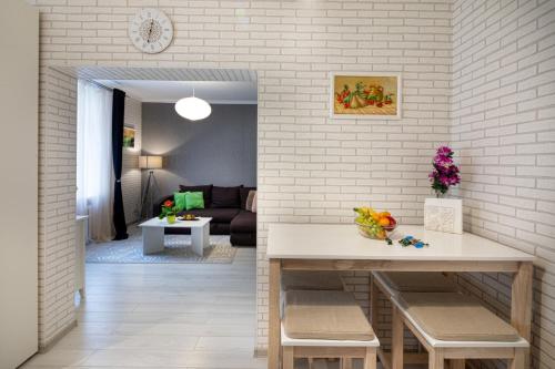 a kitchen and living room with a table in a room at Riga Centre Apartment in Riga