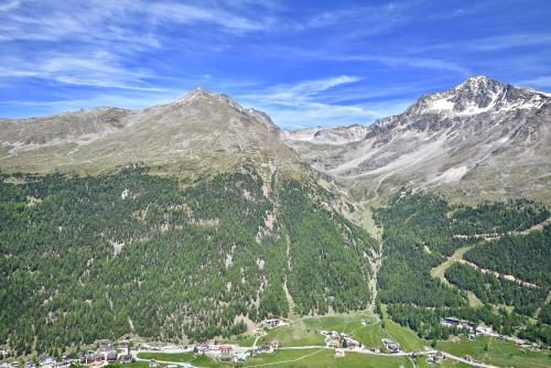 a view of a mountain range with trees and a town at Bed & Breakfast Hotel Nives in Solda
