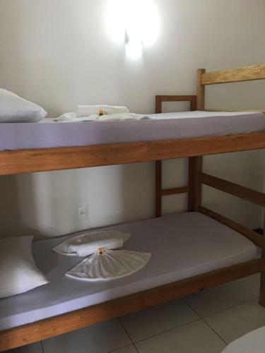 two bunk beds in a dorm room with one top at Casas Coloniais in Morro de São Paulo