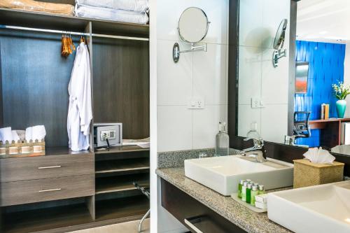 a bathroom with a sink and a mirror at Ikala Galapagos Hotel in Puerto Ayora