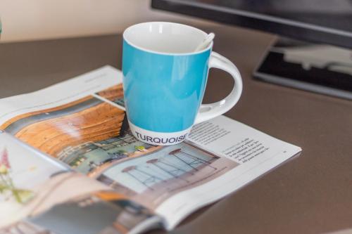a coffee cup sitting on top of a table at La Casa Rosa in Terni