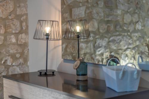 two lamps sitting on a counter in a bathroom at La Casa Rosa in Terni