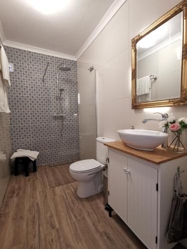 a bathroom with a sink and a toilet and a mirror at Vogue 23 Boutique Villa Cascais in Cascais