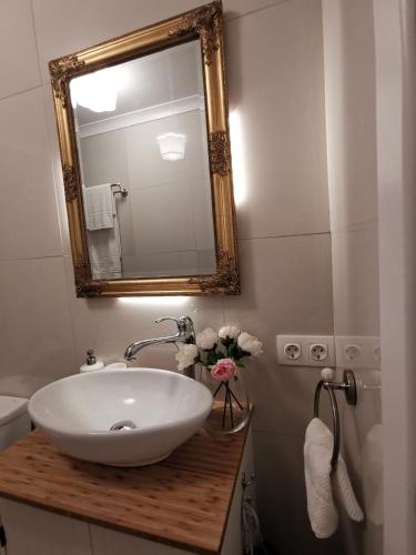 a bathroom with a white sink and a mirror at Vogue 23 Boutique Villa Cascais in Cascais