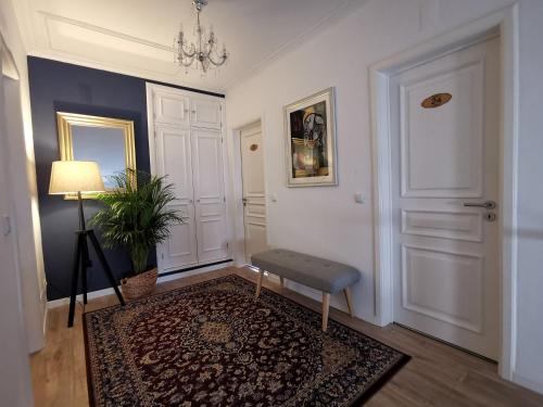 a hallway with a chair and a lamp and a door at Vogue 23 Boutique Villa Cascais in Cascais
