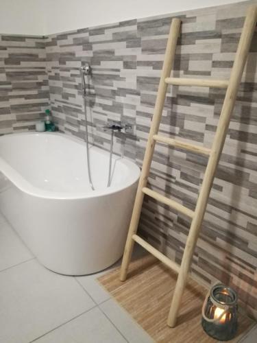 a bathroom with a bath tub and a ladder at B&B Suite Vela Bianca in Salerno
