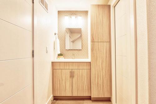 a bathroom with a sink and a mirror at Beautiful 3 Bedroom Townhouse in Old Town North, Brewery District in Fort Collins