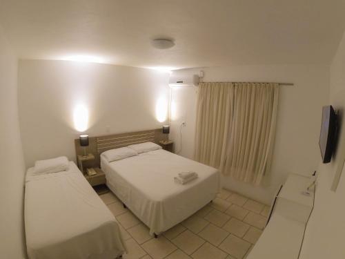 
A bed or beds in a room at Hotel São Marcos
