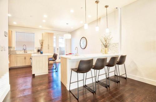 a kitchen with a bar with leather chairs in it at Beautiful 3 Bedroom Townhouse in Old Town North, Brewery District in Fort Collins