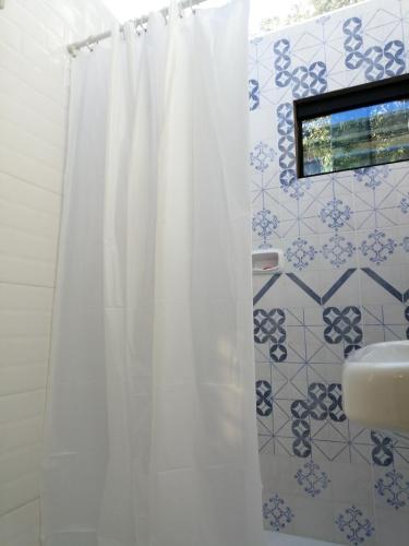 a bathroom with a shower curtain and a sink at Granados in Asuncion