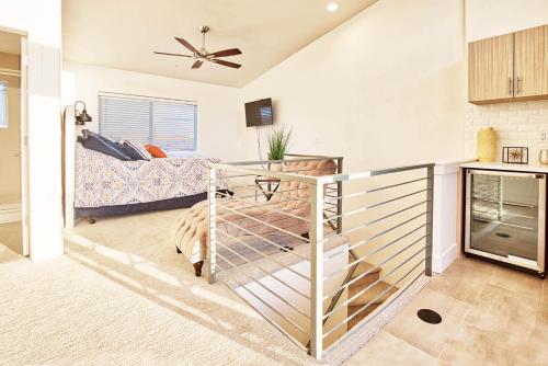 a living room with a staircase leading to a bedroom at Beautiful 3 Bedroom Townhouse in Old Town North, Brewery District in Fort Collins