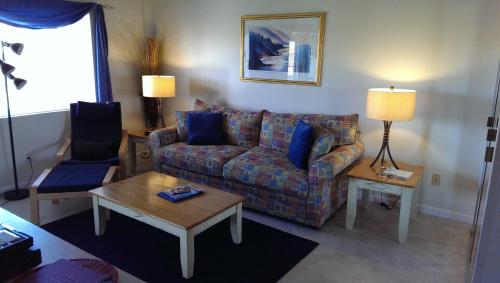 a living room with a couch and a table at Montauk Manor in Montauk