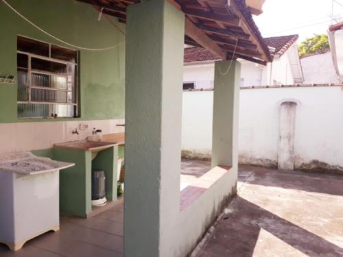 eine Küche mit grünen und weißen Wänden und einem Waschbecken in der Unterkunft CASA NO CENTRO DA CIDADE in Caraguatatuba