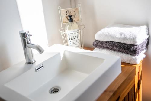 a bathroom with a sink and towels on a counter at LE ROMANTICA - Les Suites Romantiques Honfleur in Honfleur