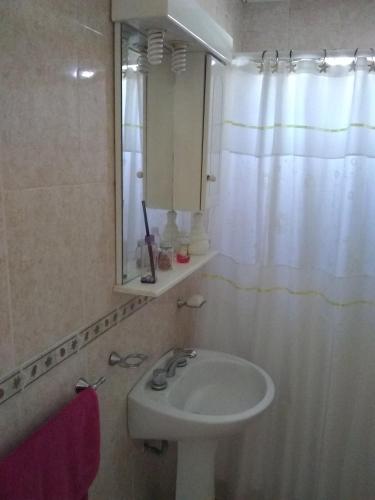 a bathroom with a sink and a mirror at La Vilma Hospedaje Familiar in Paganini
