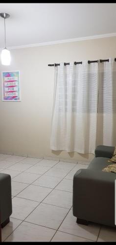 a living room with a couch and a window at Casa da Cachoeira in Brotas