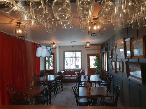 a dining room with tables and chairs and chandeliers at New Orleans Hotel in Arrowtown