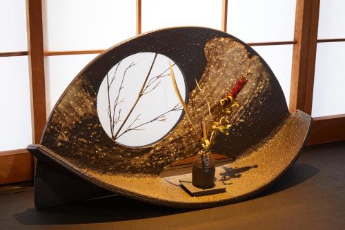 a hat with a decoration on it in a room at Rinn Tsukinuke in Kyoto