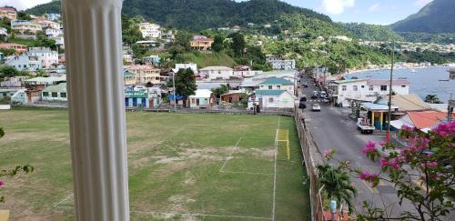 a view from a window of a town with a soccer field at Unit 2 Private Apartment - Roseau in Roseau