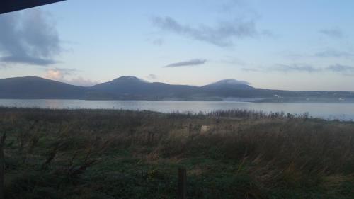 a view of a lake with mountains in the background at Harlosh Log Cabins in Dunvegan