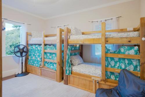 a room with two bunk beds and a fan at Hillcrest in Nassau